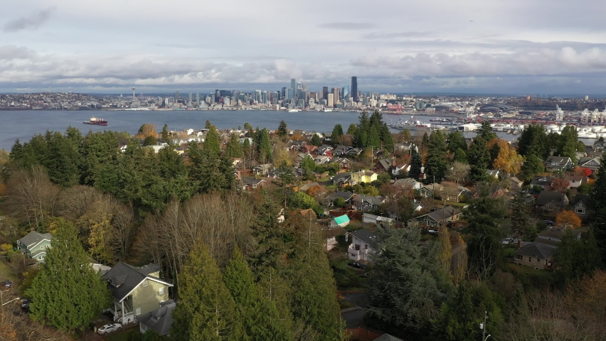 Aerial  drone reveal footage of West Seattle, view of downtown Seattle, Harbor Island, Industrial Districts, Seattle Harbor, ferry, cruise terminals, Elliott Bay in Seattle, King County, Washington