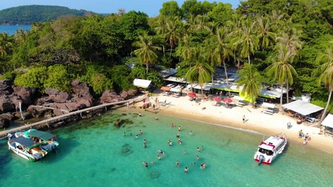 Aerial view of beautiful landscape, tourism boats, and people swimming on the sea and beach on May Rut island (a tranquil island with beautiful beach) in Phu Quoc, Kien Giang, Vietnam. Travel concept