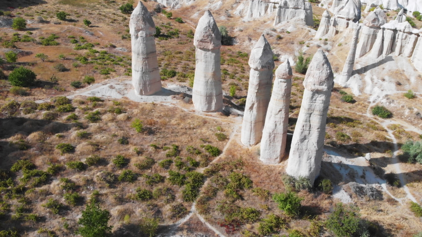 Cappadocia aerial drone view to Love Valley volcanic rock formations and fairy chimneys, Goreme, Turkey.