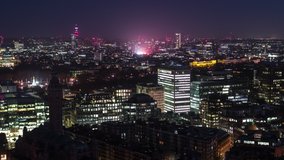 Establishing Aerial View Shot of London UK, Westminster, Victoria at night evening, city skyline, United Kingdom