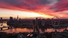 Establishing Aerial View Shot of London UK, jaw dropping sunrise over capital and River Thames, United Kingdom, track back