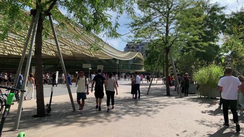 PARIS - CIRCA AUGUST, 2019: Footage of people walking at main train station and famous shopping mall called "Les Halles" in Paris. It is a sunny summer day. Camera moves forward.