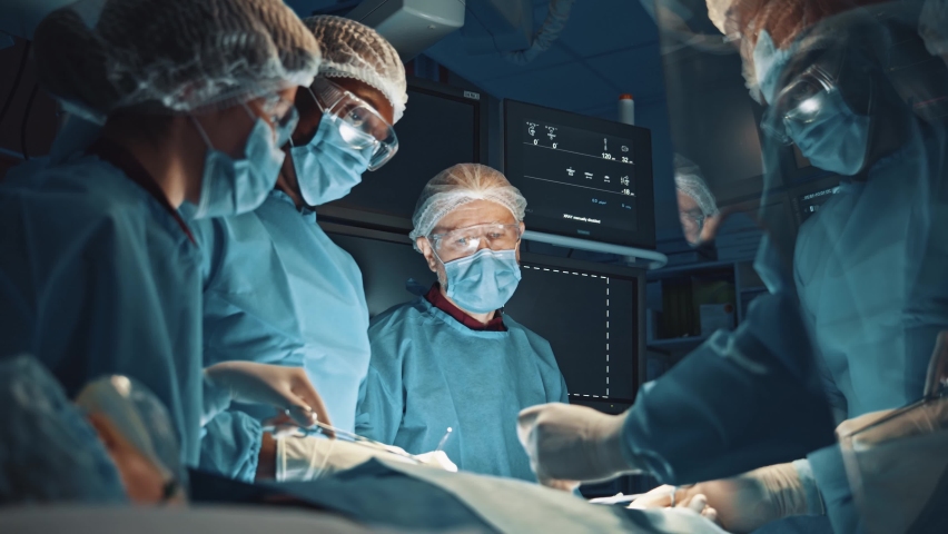 General surgeon. Attentive medical workers operating their patient. A surgery like this requires anesthesiologist, a general surgeon to remove tumor and, at least two surgical nurses. Medical concept | Shutterstock HD Video #1063997440