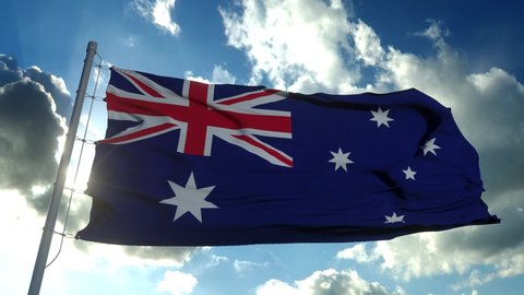 The national flag of Australia blowing in the wind against a blue sky