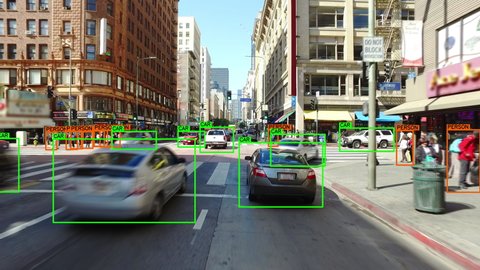 Autonomous or driverless car driving through a crowded street in Los Angeles. Computer vision with object detection system that creates boxes to recognize the different objects in the streets. AI.