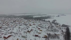 Winter in the city, a lot of snow on the roofs of houses in the private sector, taken from a height of 4K quality, beautiful winter landscapes, it's snowing. Video sketch of winter nature.