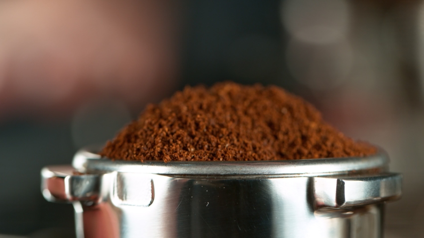Close-up Slow Motion of Grinder Stuffing Roasted Coffee from Coffee Machine. Filmed on High Speed Cinematic Camera at 1000 fps. Royalty-Free Stock Footage #1064013382