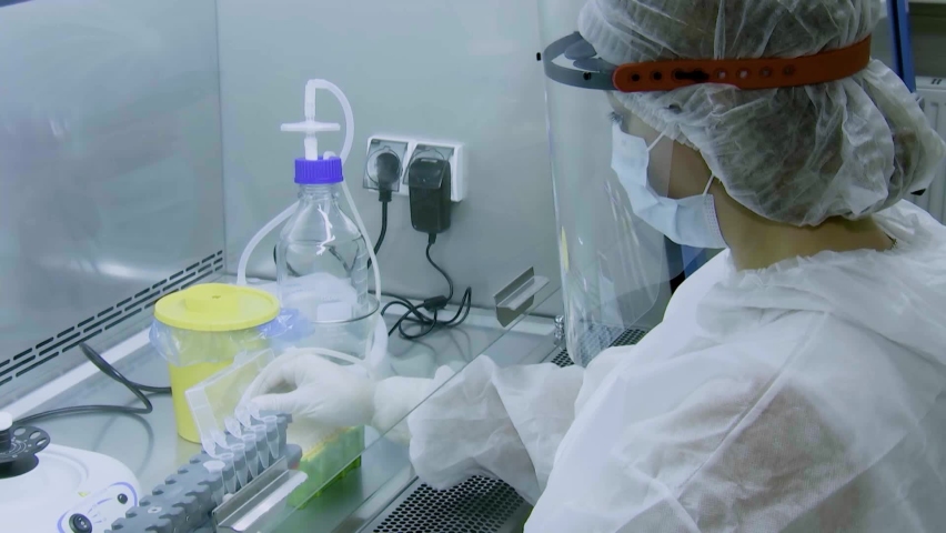 A laboratory assistant performs a test for COVID-19 by polymerase chain reaction. Royalty-Free Stock Footage #1064014261