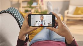 medical support,female using smart phone to talk to doctor via video chat application,sick woman has conversation with physician using smartphone online medical app,medic talking to patient video call