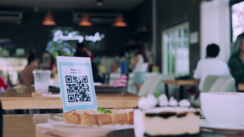 Women using their phones for scanning to pay for coffee and cake on cafe. Mobile scanning system oline for pay money . Concept technology for pay by scan QR code. Royalty-Free Stock Footage #1064025844