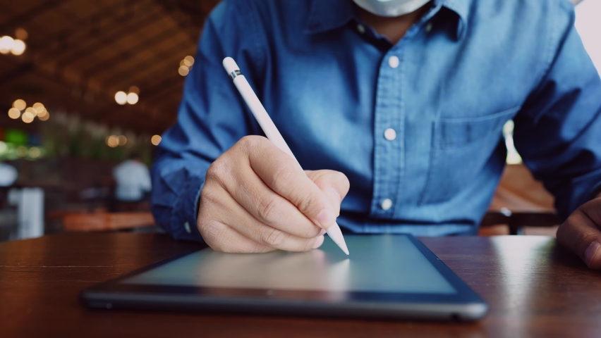 A young businessman is doing a video conference with customers via a tablet that is connected to the Internet