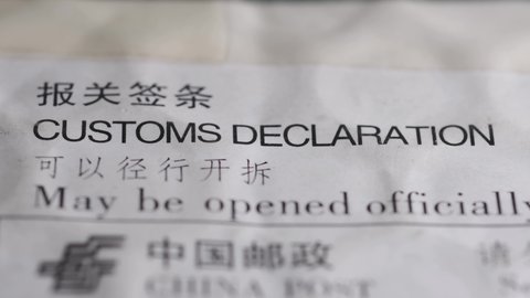rack focus footage of postal envelope with customs declaration sign