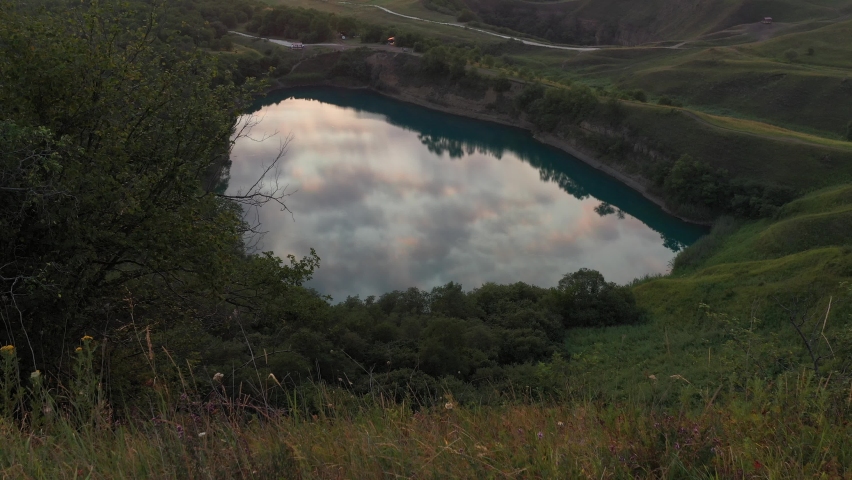 Sunset in the foothills. Picturesque lake and sunset over the Autumn hills. no color grading
