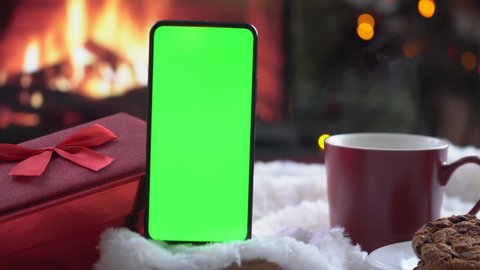 Smartphone with green screen on Christmas background