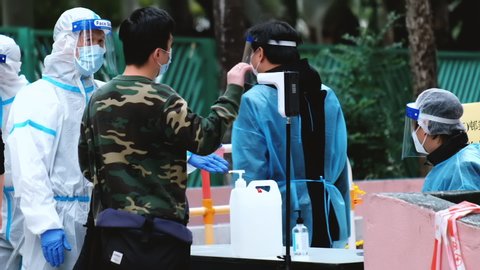 Hong Kong - December 15, 2020: People go to covid-19 testing center outdoors on street, coronavirus concept.