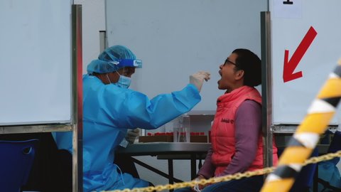 Hong Kong - December 15, 2020: A doctor taking a nasal swab from a person to test for possible coronavirus infection.