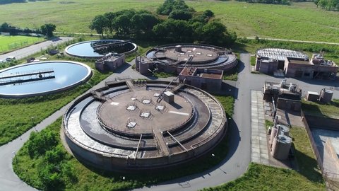 Aerial view of water treatment plant which provides the process that improves the quality to make it appropriate for a specific end-use this is crucial to human health 4k high resolution footage
