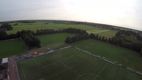 Drone aerial fly over green sport field soccer fields hockey fields and tree lines farmland behind this sport complex great view flight view from cockpit helicopter bird eye view  high resolution 4k