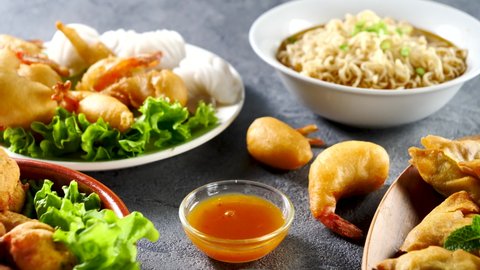 assorted of asian food- spring roll, fried shrimp, noodles