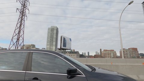 Toronto, Ontario, Canada December 2020 POV side view driving into downtown Toronto skyline office towers and condos