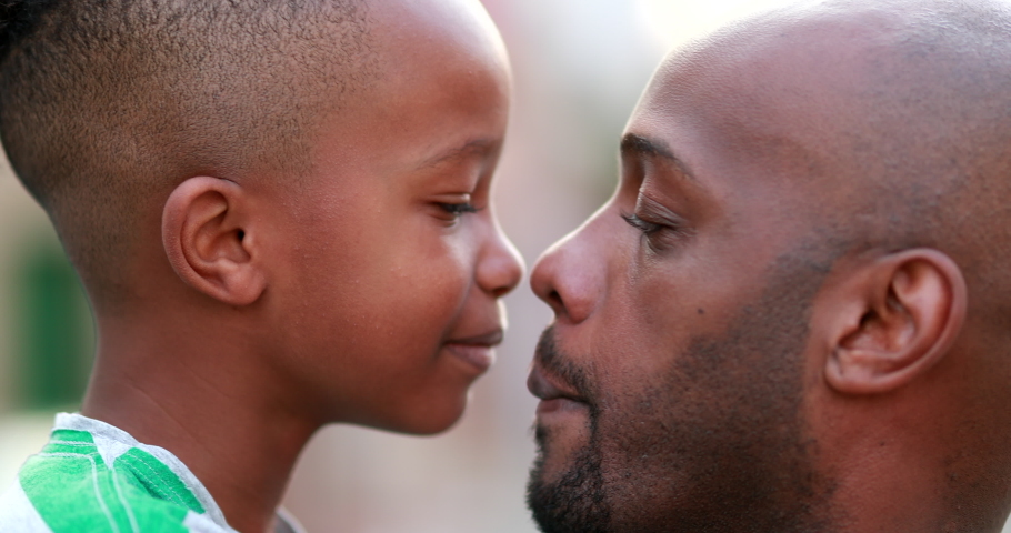 Beautiful father and child bonding together. African black parent and son bonding, doing eskimo kiss