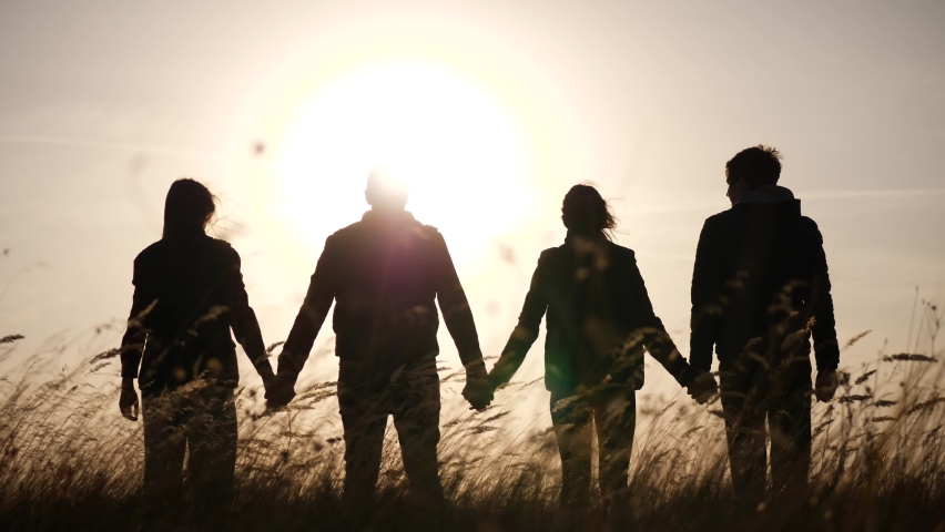 Teamwork. team community hold hands together silhouette at sunset unity. group of people hands. teamwork a workers carry out put your hands up. business team in the company working partnership | Shutterstock HD Video #1064059432