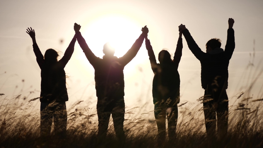 Teamwork. team community hold hands together silhouette at sunset unity. group of people hands. teamwork a workers carry out put your hands up. business team in the company working partnership | Shutterstock HD Video #1064059432
