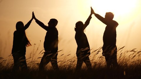 teamwork. team of tourists greet each other rejoice in success silhouette. business teamwork a travel tourism success concept. group of people clap each other symbol team of victory