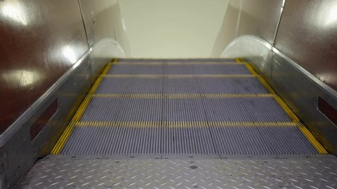 Subway escalator for passengers. Modern empty working escalator goes up.