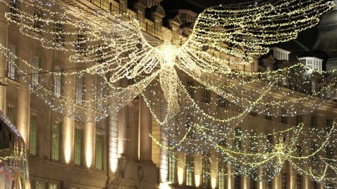 LONDON, UK - DECEMBER 9, 2020: Christmas Lights Angel reflecting off passing bus on Regent Street, London, England, UK