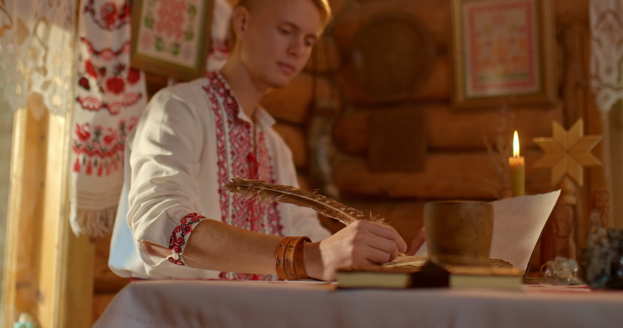 Close-up, pen in hand of a Slavic man, writes in a book. Ancient Russian hut, customs of the Slavs. 4k, ProRes