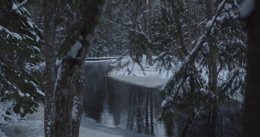 River in wild snow covered deep forest in winter