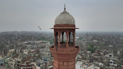 Lahore, Pakistan - August 17th, 2020: Badshahi Mosque's Minaret in a closeup and circular shot taken through a drone.