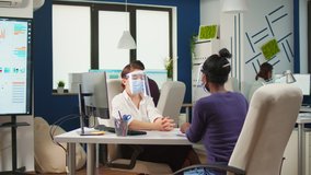 African employee and coworker with face masks planning financial project typing on computer and discussing sitting in business office with new normal. Multiethnic team respecting social distance - Powered by Shutterstock - Get 15% off with code: PIKWIZARD15