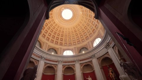 Vatican City, Italy - April 17 2019: Wide shot of aesthetic design of different elements and shapes in an enormous building in Vatican City. Vintage interior style in shades of brown and red.