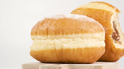 Doughnuts with boiled condensed milk on a white background, donut bite mark. Delicious sweet donut rotating.