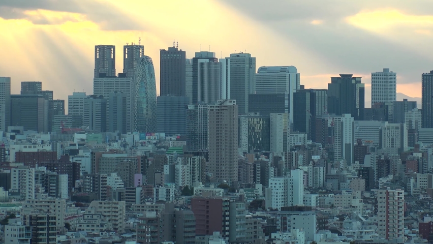TOKYO, JAPAN : Aerial high angle sunrise CITYSCAPE of TOKYO. View of office buildings at downtown area around Shinjuku. Japanese urban metropolis concept shot. Long time lapse shot night to morning.
