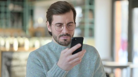 Portrait of Young Man Talking on Smartphone