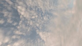 A passenger airliner flies in the sky. Sky time lapse, airplane fly by. Beautiful Universally Cloudscape background. Vertical video.