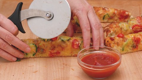  Homemade Italian flat bread focaccia with cherry tomatoes and chili pepper close up on rustic wooden background served with tomato sauce