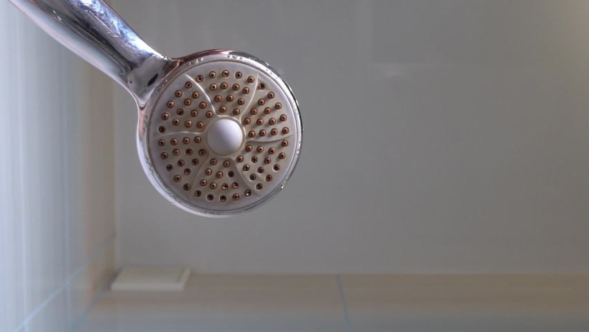 Shower. Take a shower. Morning shower. Wake up in the morning. Pure water flows from the shower in slow motion. Water flows into the camera lens. Royalty-Free Stock Footage #1064112778