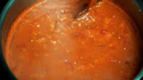Homemade Turkish Recipe Organic Food In Pot.Tasty Vegan Soup Boiling In Saucepan.Close Up Hot Lentils Soup In Pan With Wooden Spoon.Chef Cooking And Stirring Red Tomato Vegetables Soup With Spices - Powered by Shutterstock - Get 15% off with code: PIKWIZARD15