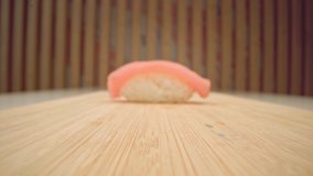 Zoom in video of nigiri sushi piece, fish on rice close up