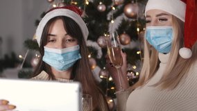 Two friends and happy family celebrating Christmas using a video call. Family greeting their relatives and friends on Christmas eve online. Social distancing, self isolation during quarantine.