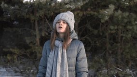 Kazan, 12.12.2020: girl in company clothes Conceptline blows steam out of her mouth in the cold. High quality 4k footage