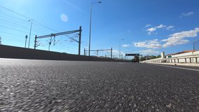 Fast moving video of national road with clear blue skies taken by stabilised camera attached to motorcycle as seen from asphalt road perspective 