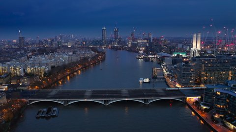 London, United Kingdom. Aerial view over the city at night. Thrilling sights of Thames and London Bridge. High quality 4k footage