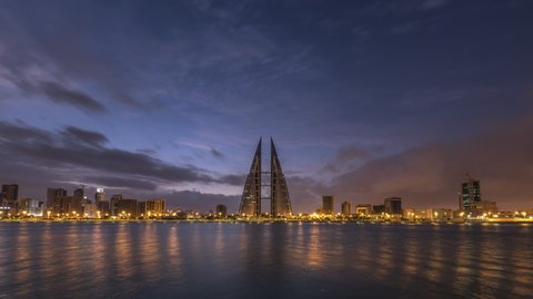 MANAMA, BAHRAIN - DECEMBER 16, 2020 - 4k Time lapse video Bahrain World Trade Center with dramatic clouds over Manama Cityscape.