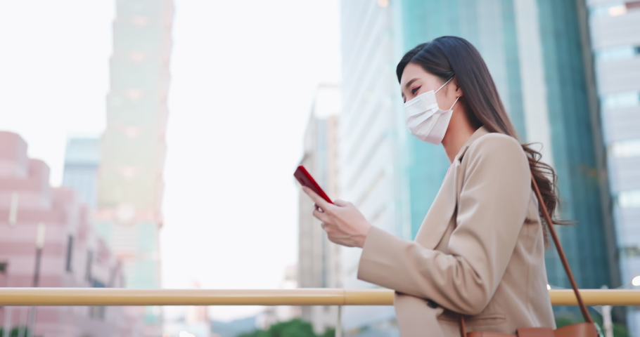asian woman use smartphone outdoor with face mask while commuting Royalty-Free Stock Footage #1064131405