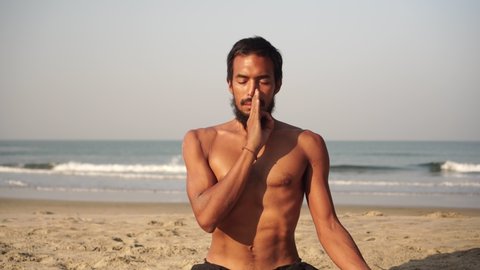 Young man doing yoga and meditation outdoors in nature